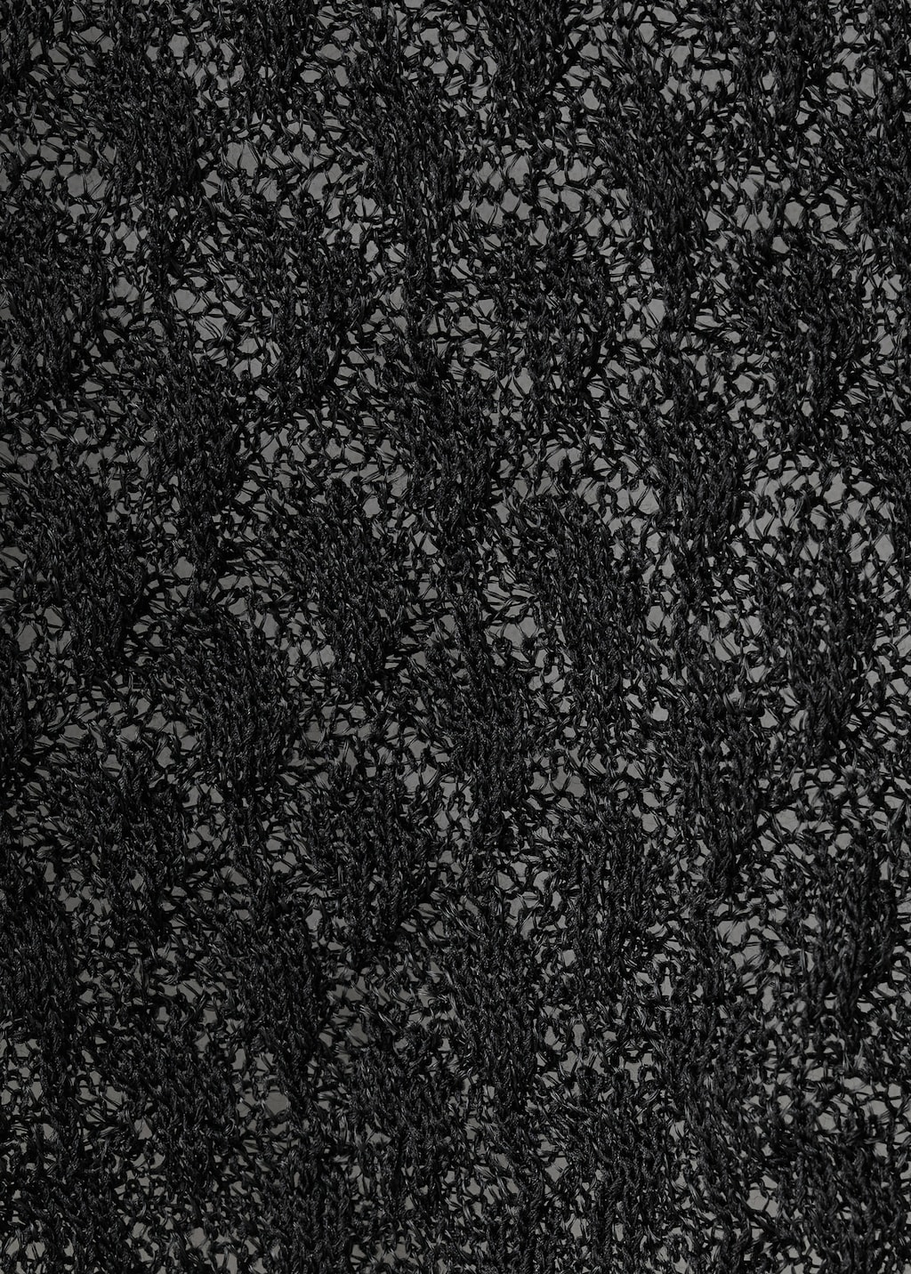 Openwork knitted sweater with bead fastening