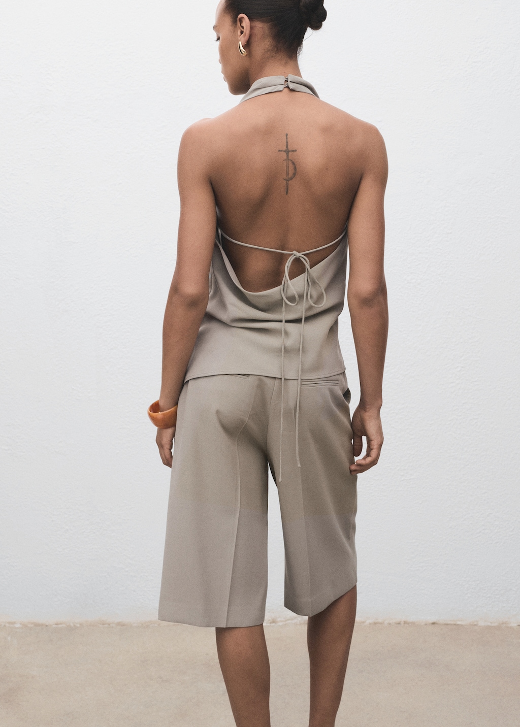 Asymmetrical open-back top