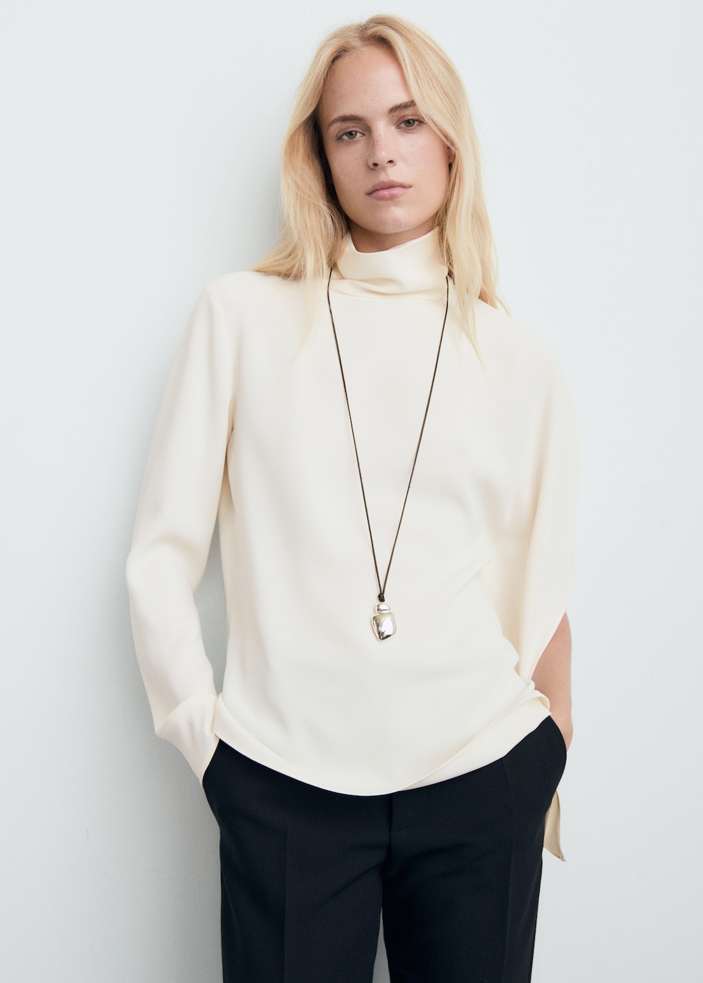 High-neck blouse with asymmetrical sleeves