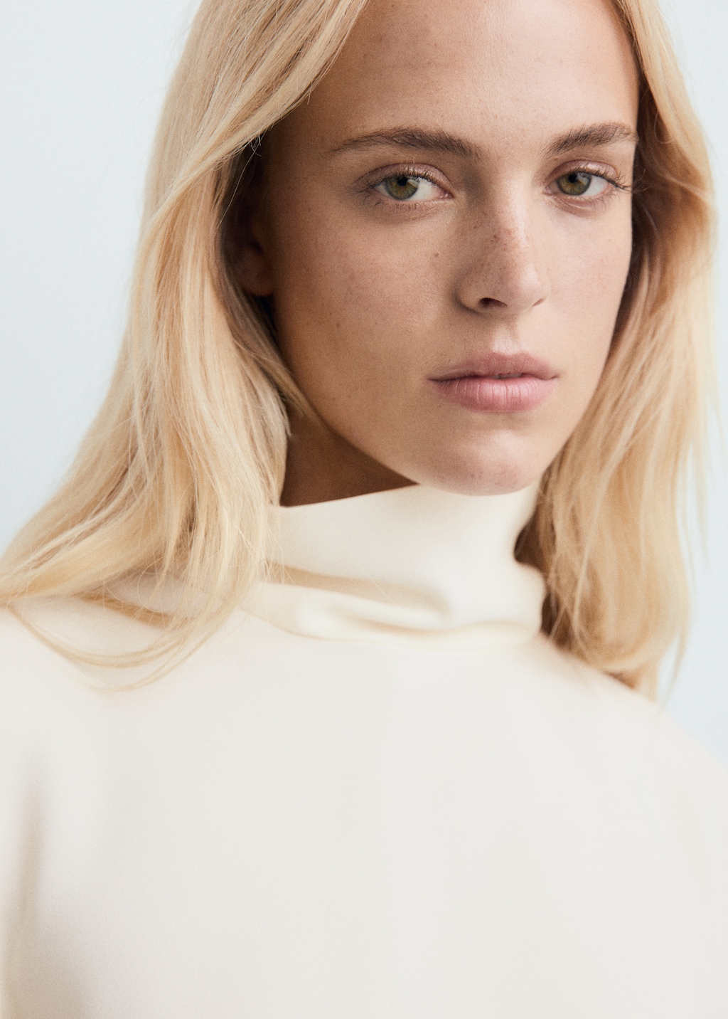 High-neck blouse with asymmetrical sleeves