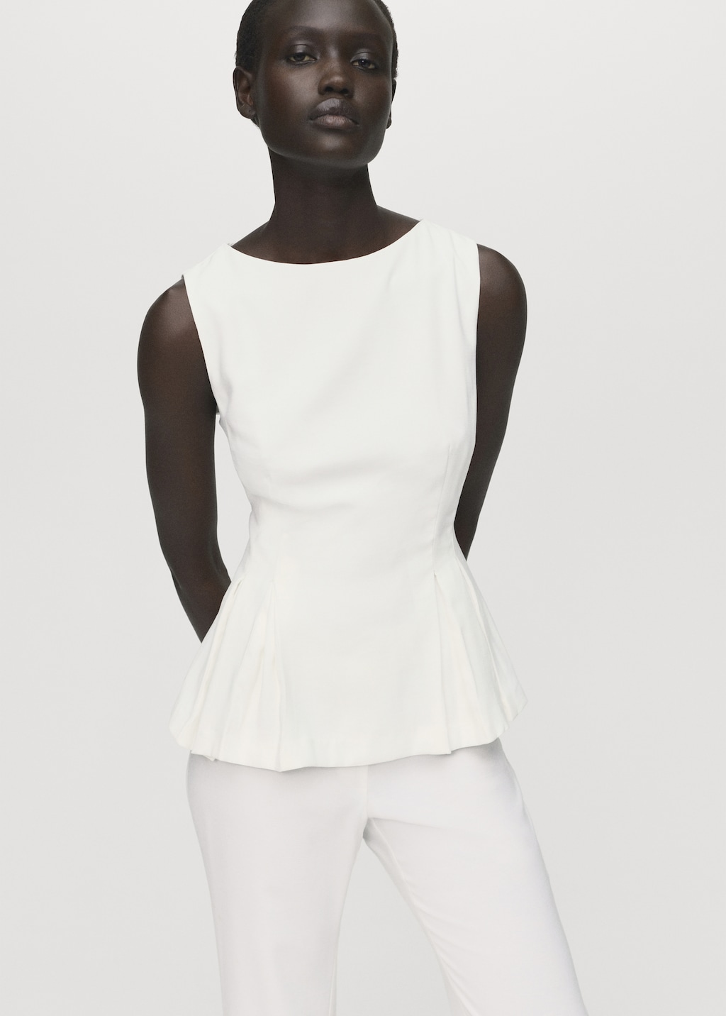 Peplum top with pleat detail