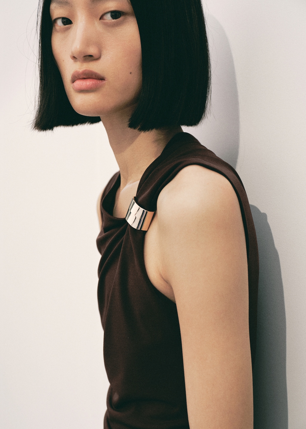 Dress with asymmetrical neck and metallic detail