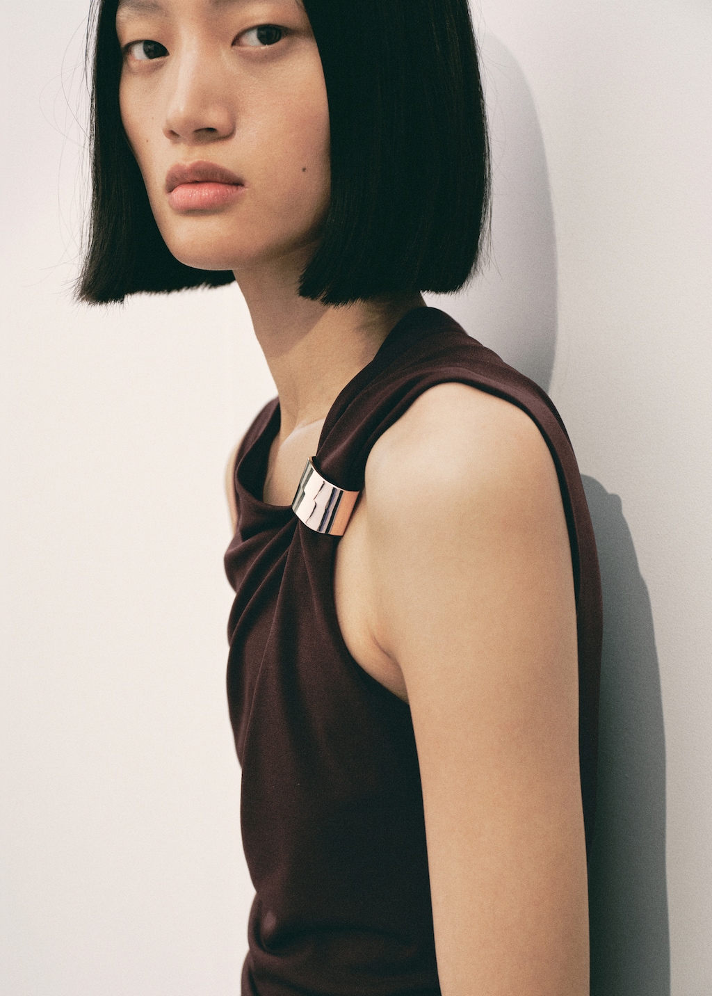 Dress with asymmetrical neck and metallic detail