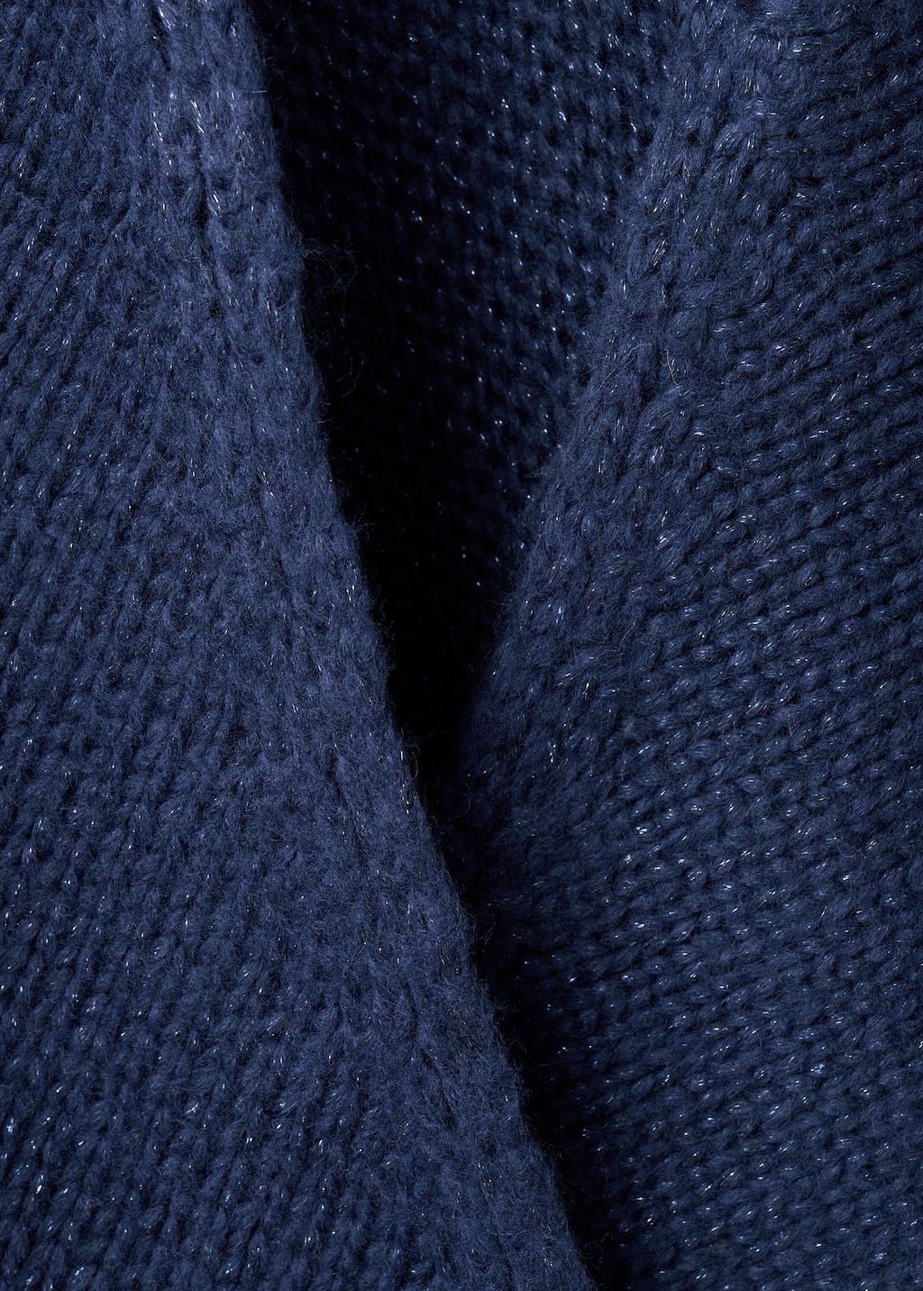 Knitted poncho with tassels