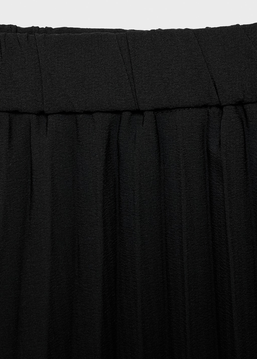 Pleated asymmetric skirt