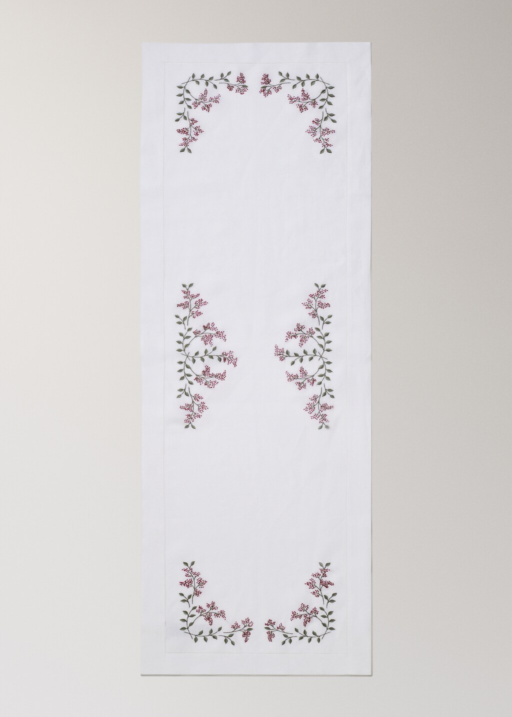 Linen table runner with embroidered floral Christmas designs