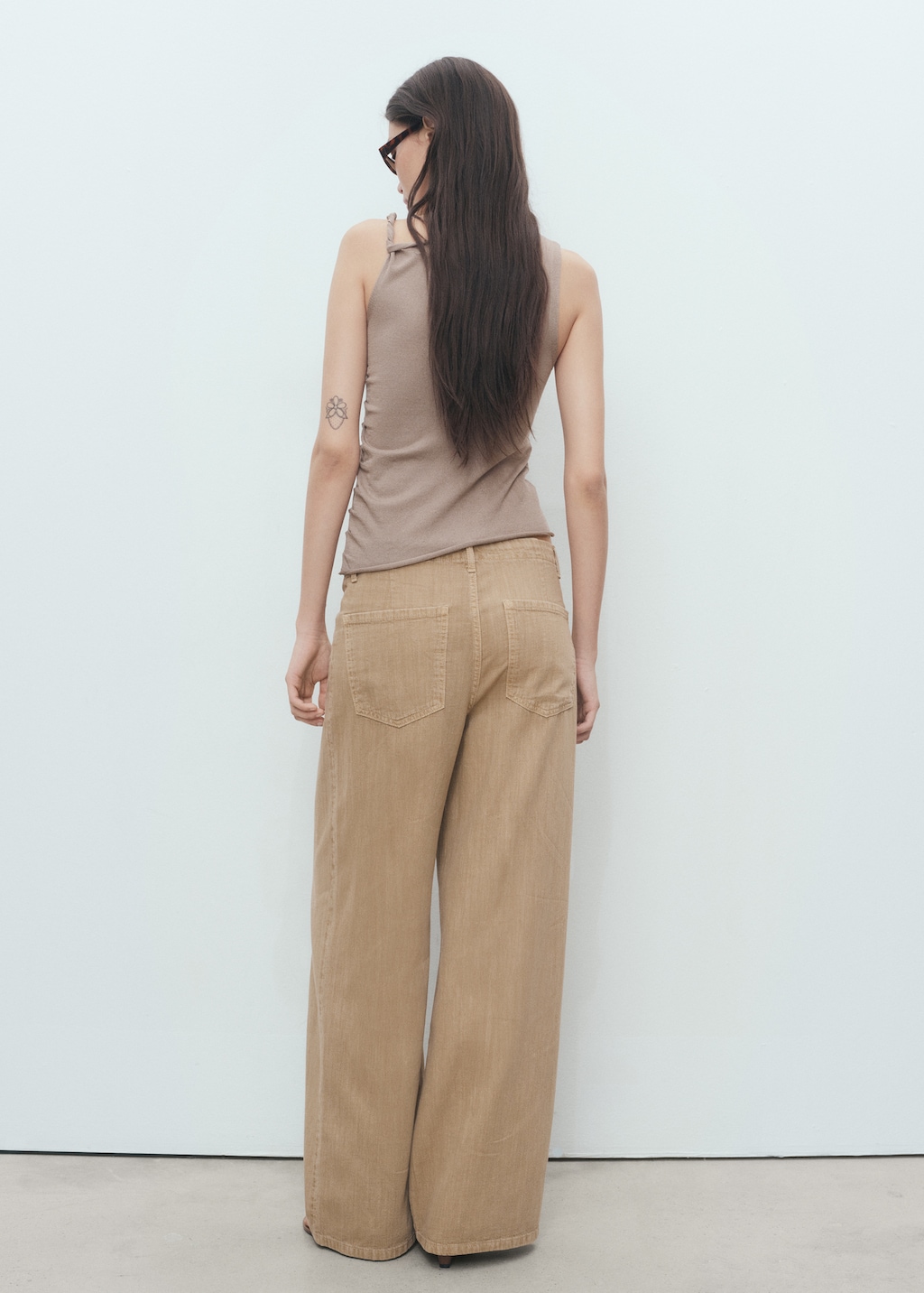 Asymmetrical knitted top with straps