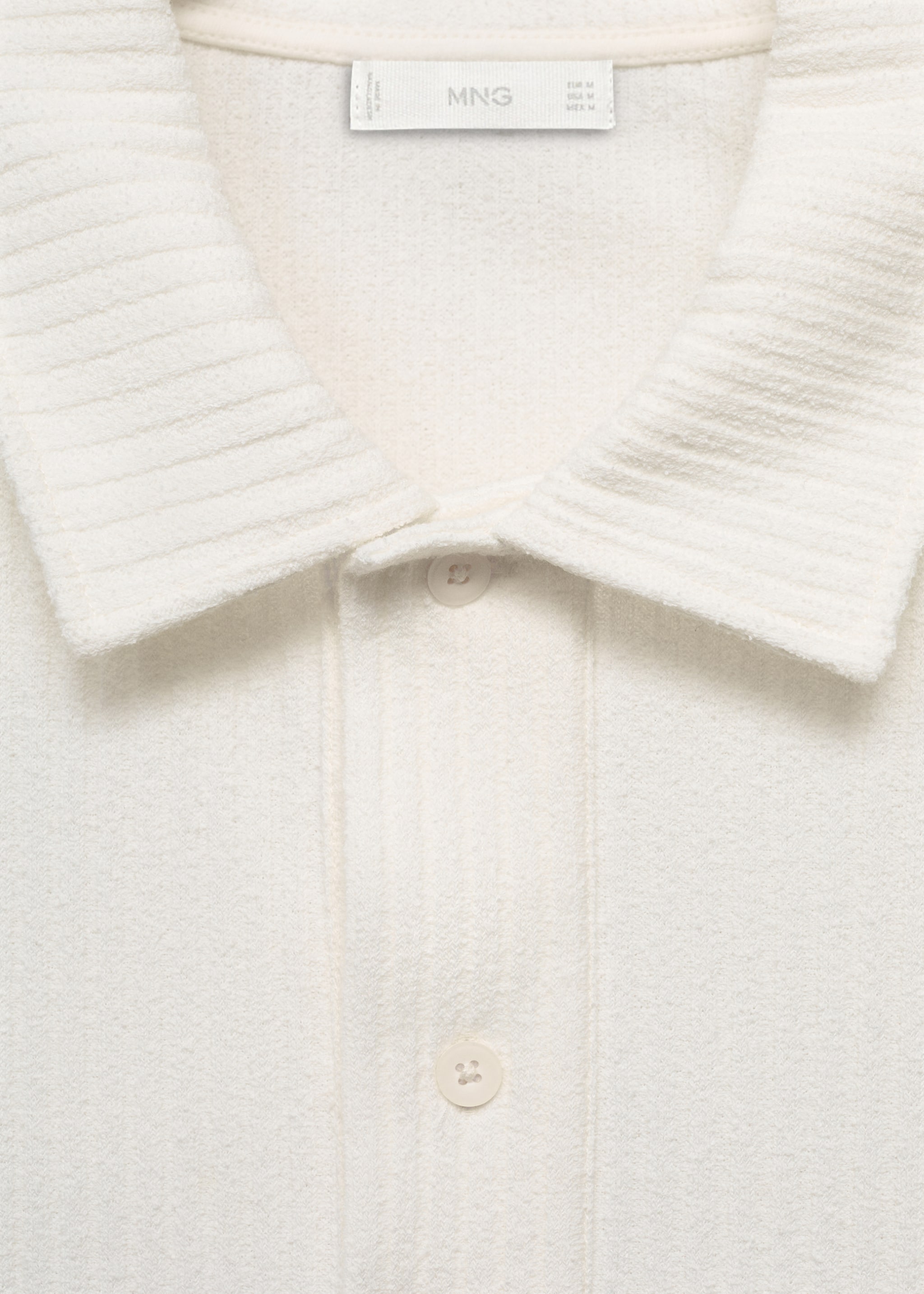 Polo de malha com textura - Pormenor do artigo 8