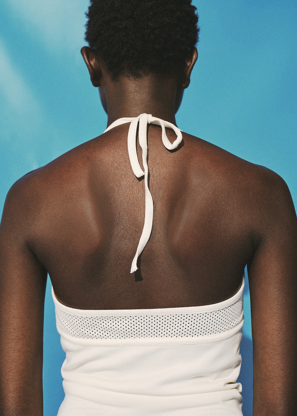 Top with perforated neckline