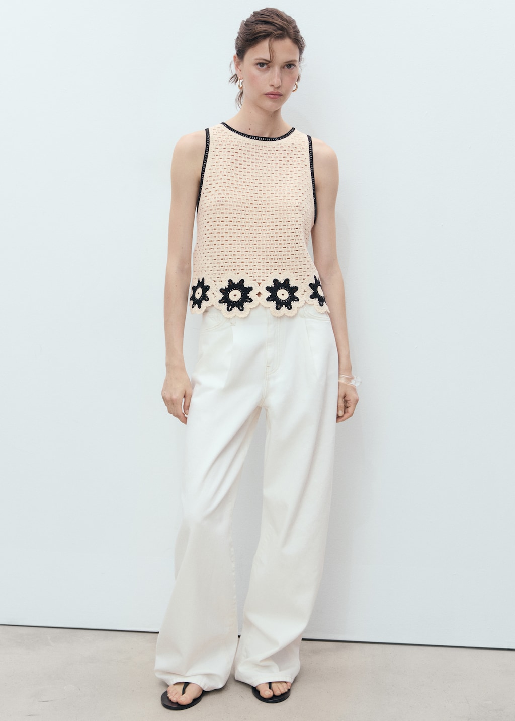 Crochet top with floral finishes