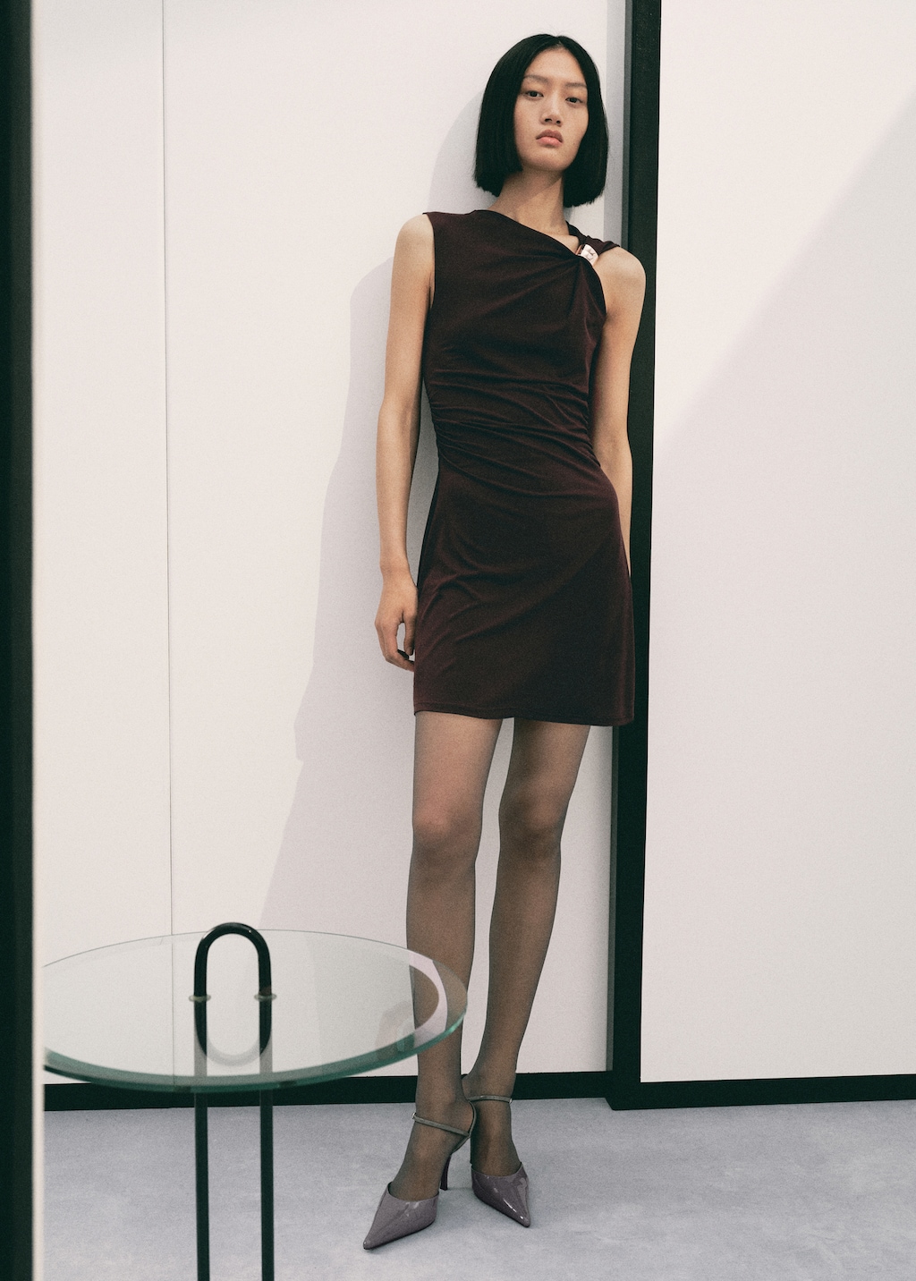 Dress with asymmetrical neck and metallic detail