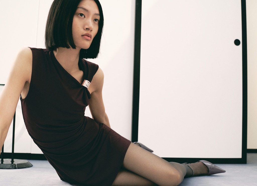 Dress with asymmetrical neck and metallic detail