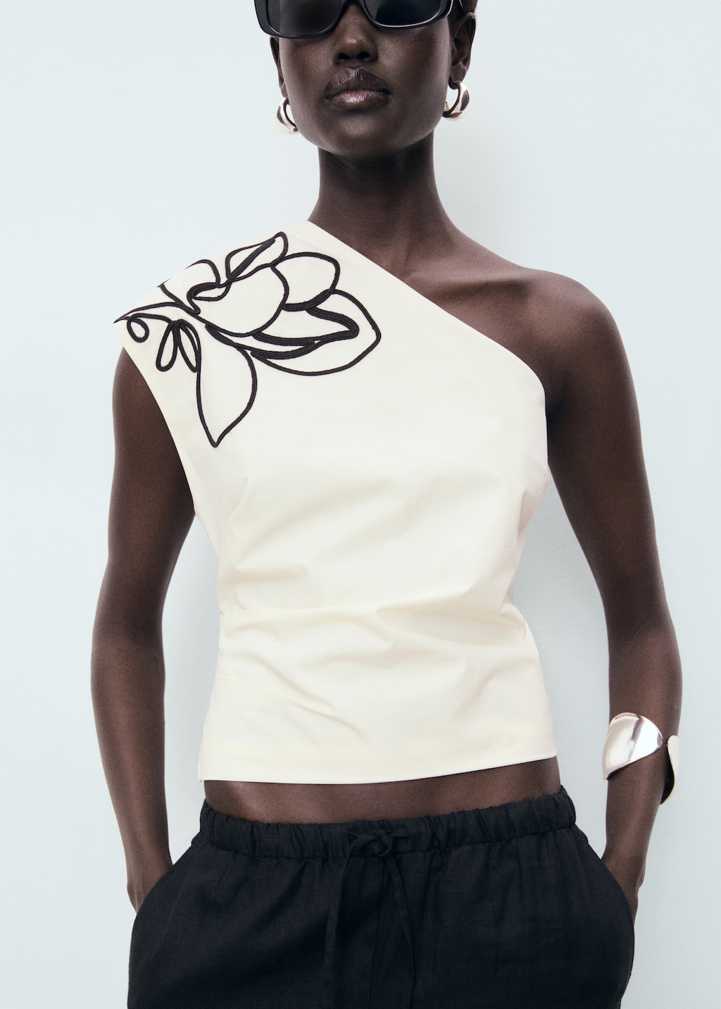 Asymmetrical flower-embroidered top