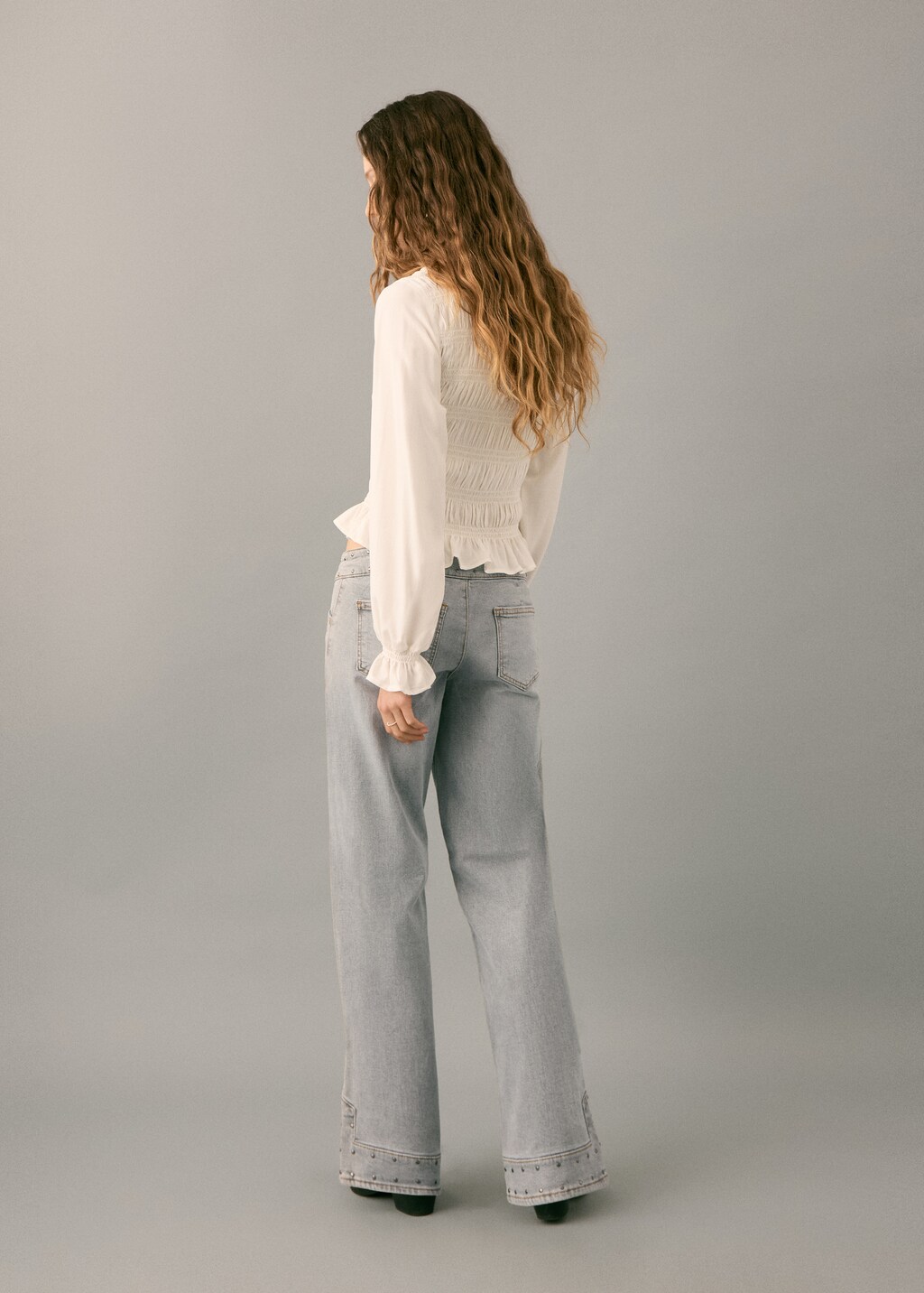 Low-waist studded jeans