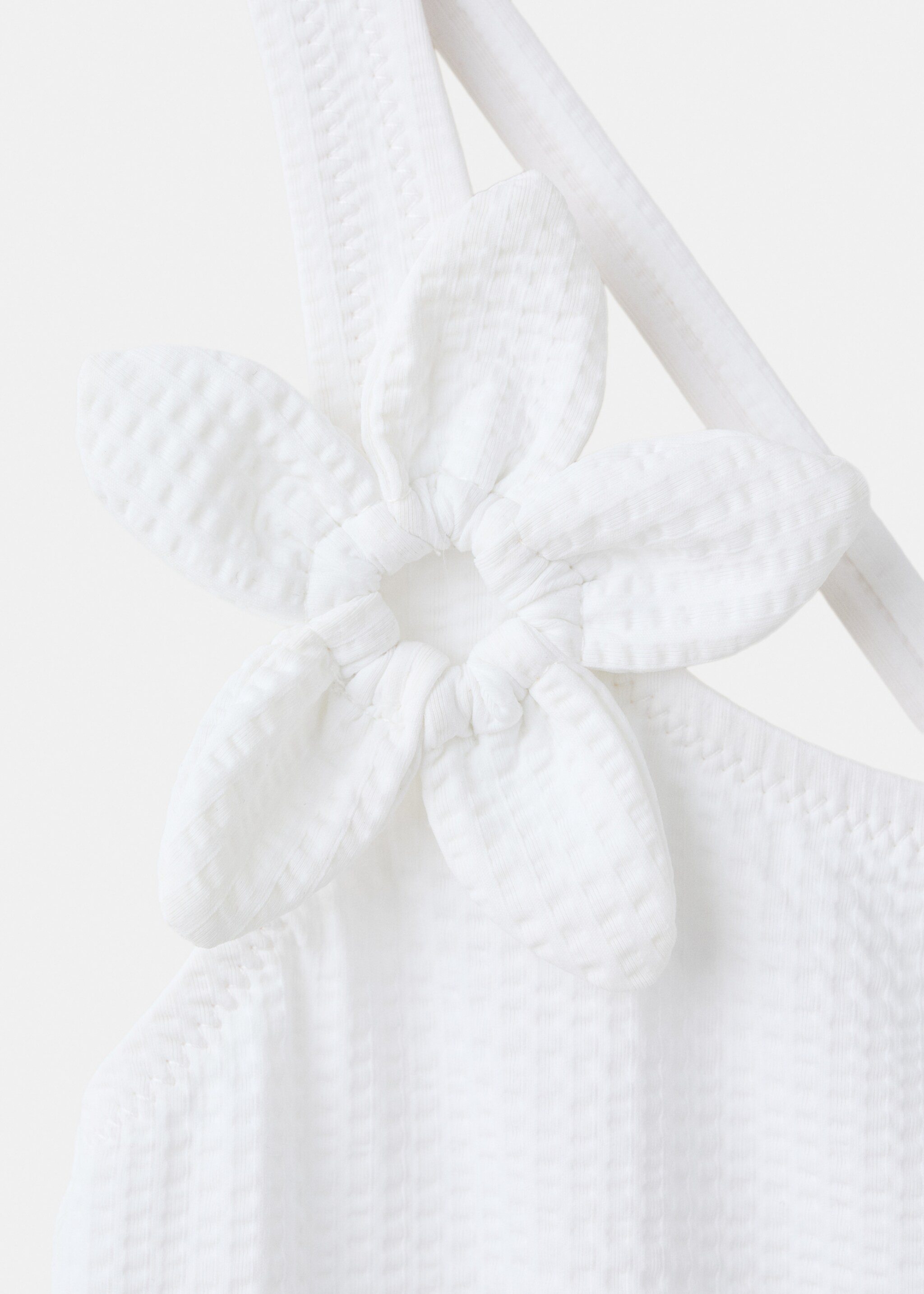 Asymmetric swimsuit with raised flower - Details of the article 8, White. Ref: 27017898-00.