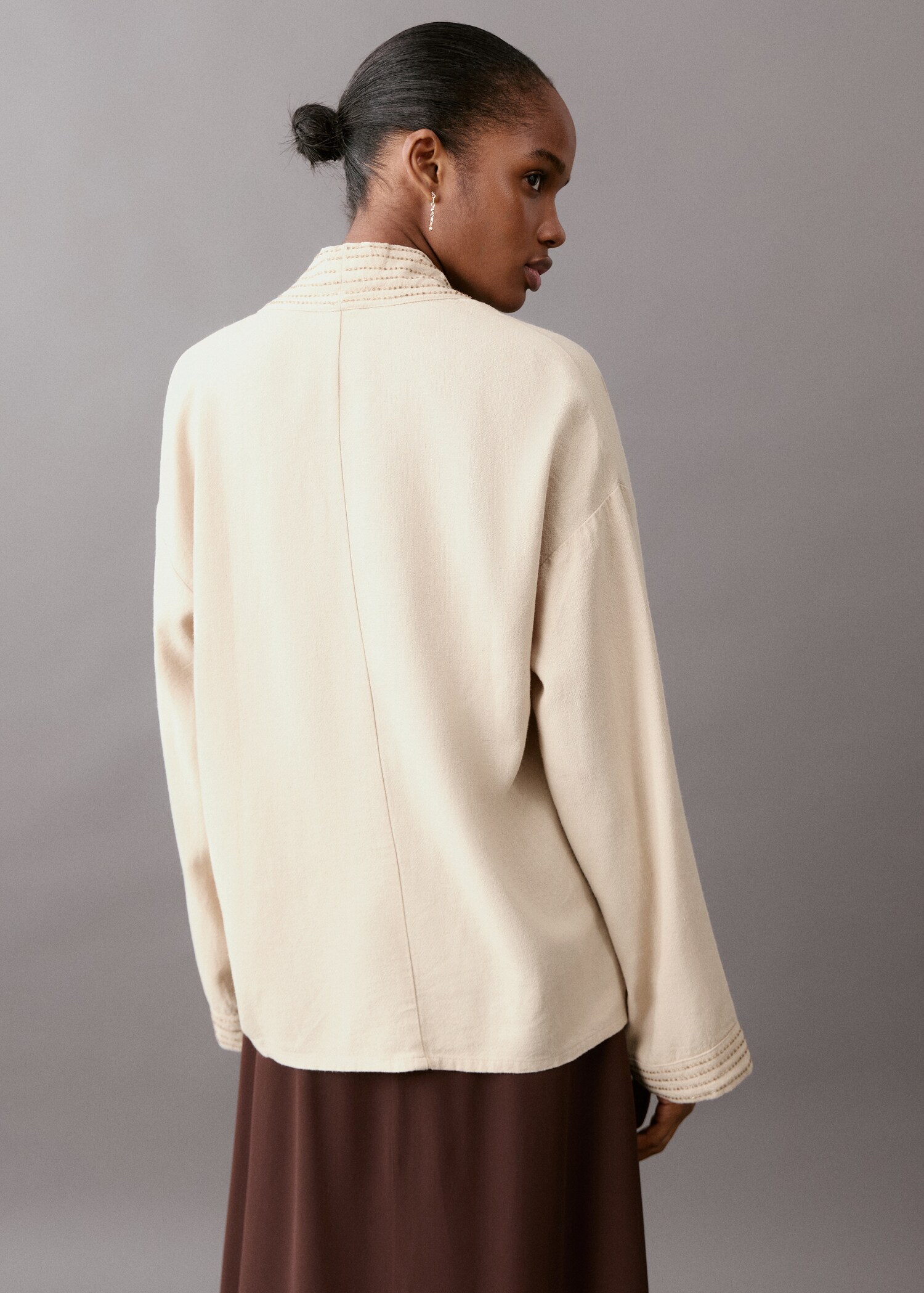 Open jacket with stitched details - Reverse of the article