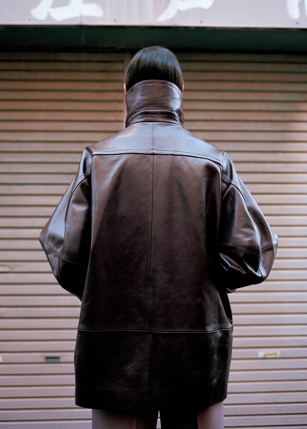 Oversized funnel-neck leather coat