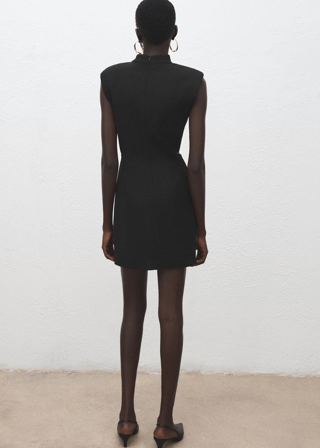 Dress with metal embellishment and cut-out