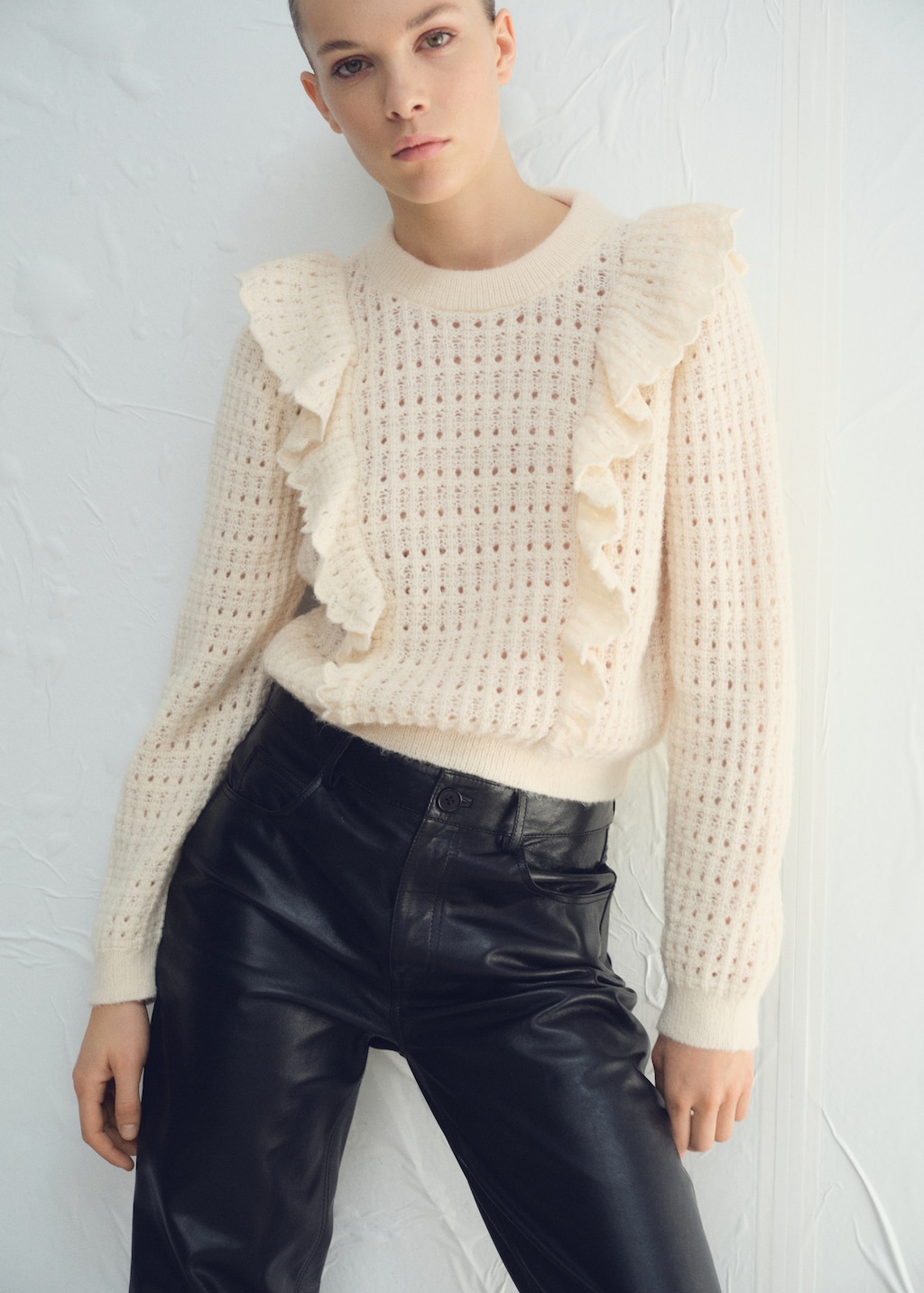 Openwork knitted sweater with ruffles