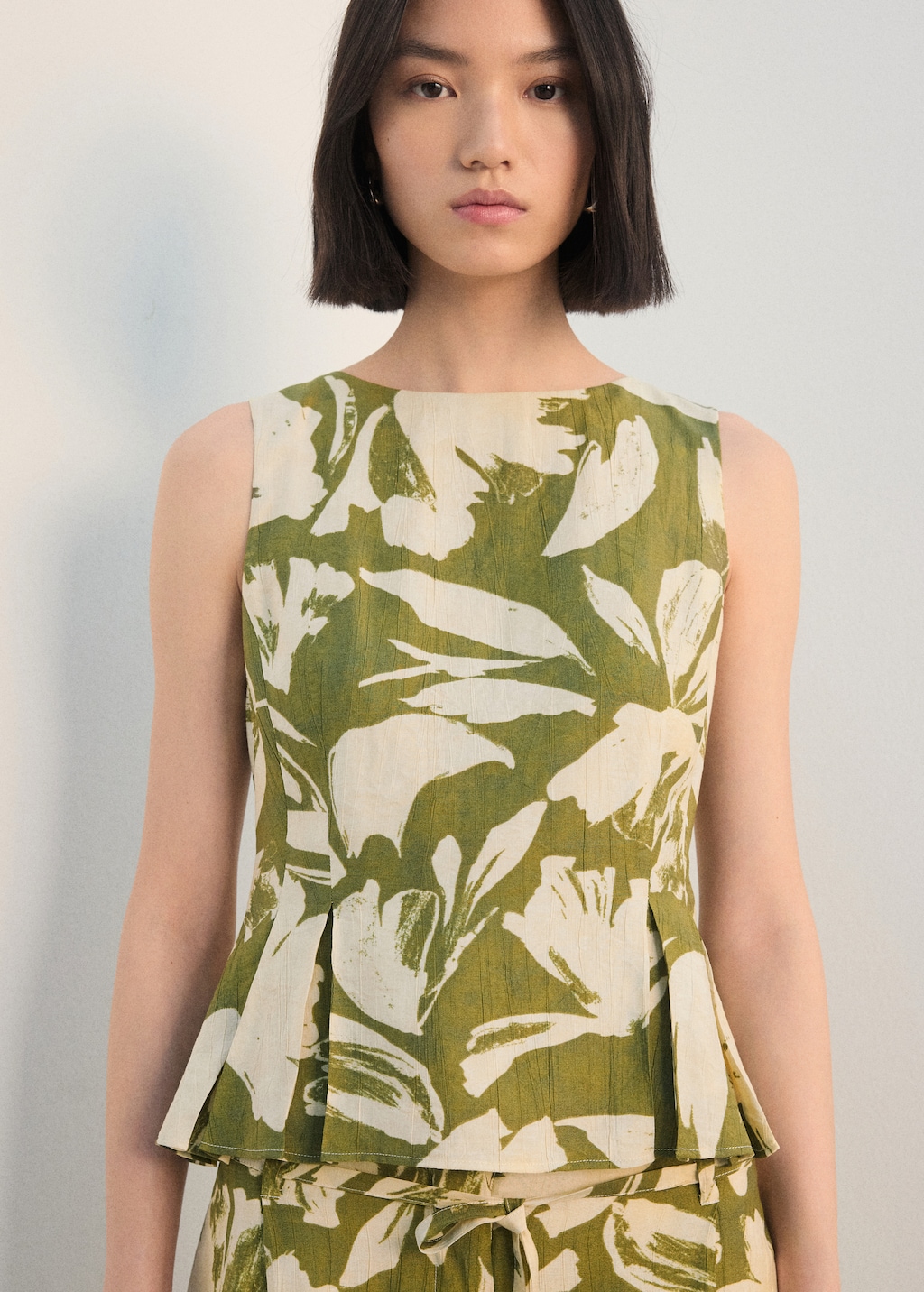 Peplum top with pleated panels