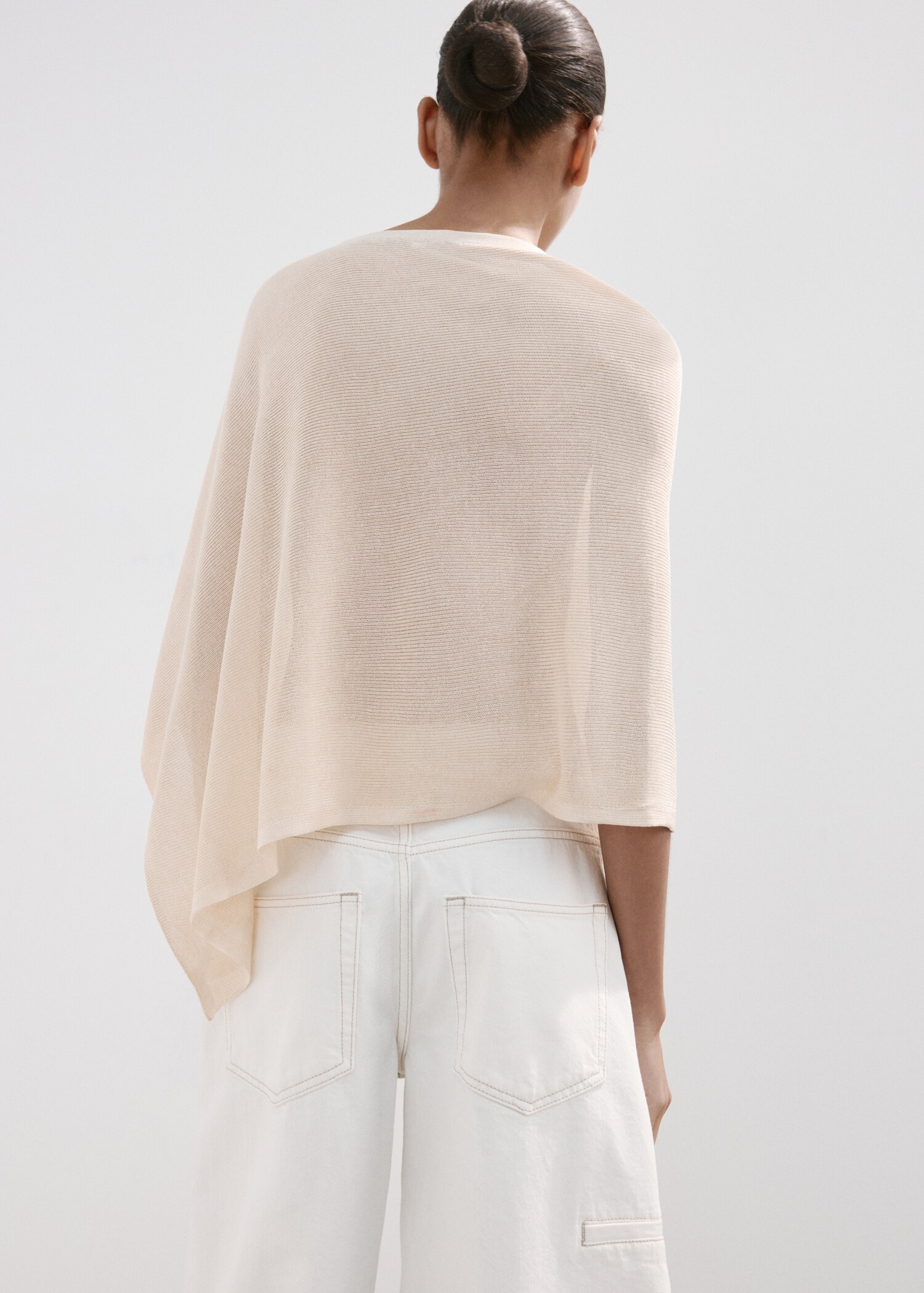 Asymmetrical knitted cape - Reverse of the article