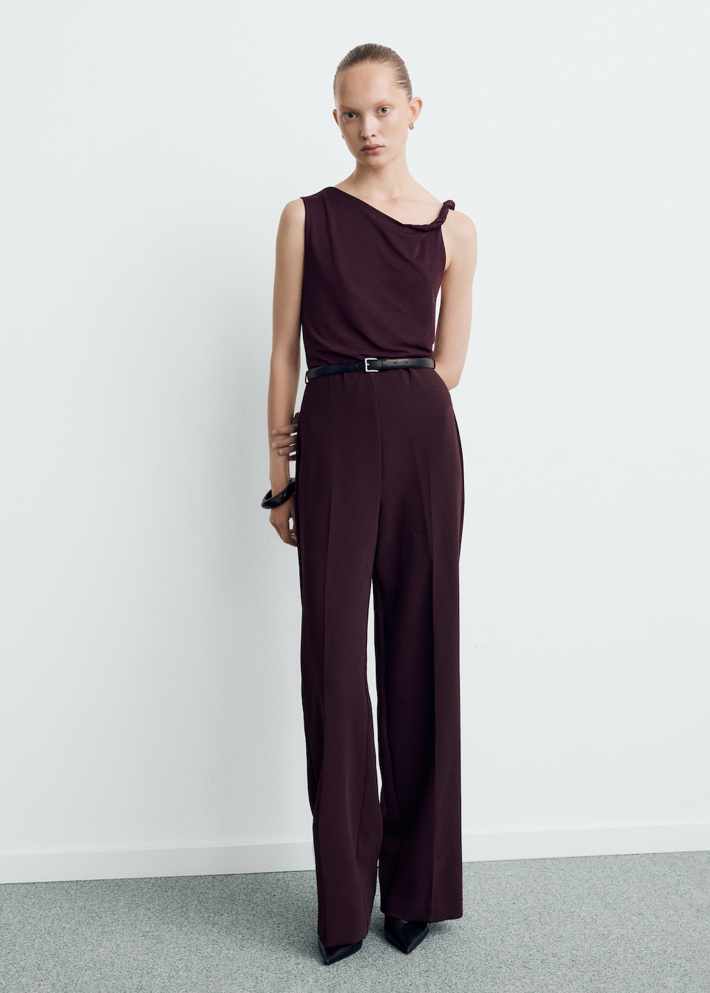 Jumpsuit with asymmetrical neckline and belt