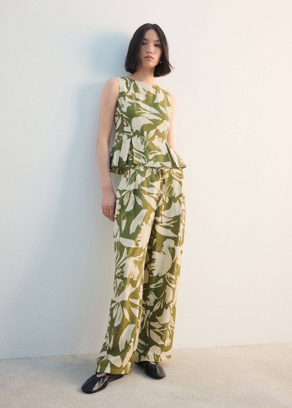 Peplum top with pleated panels - image 2
