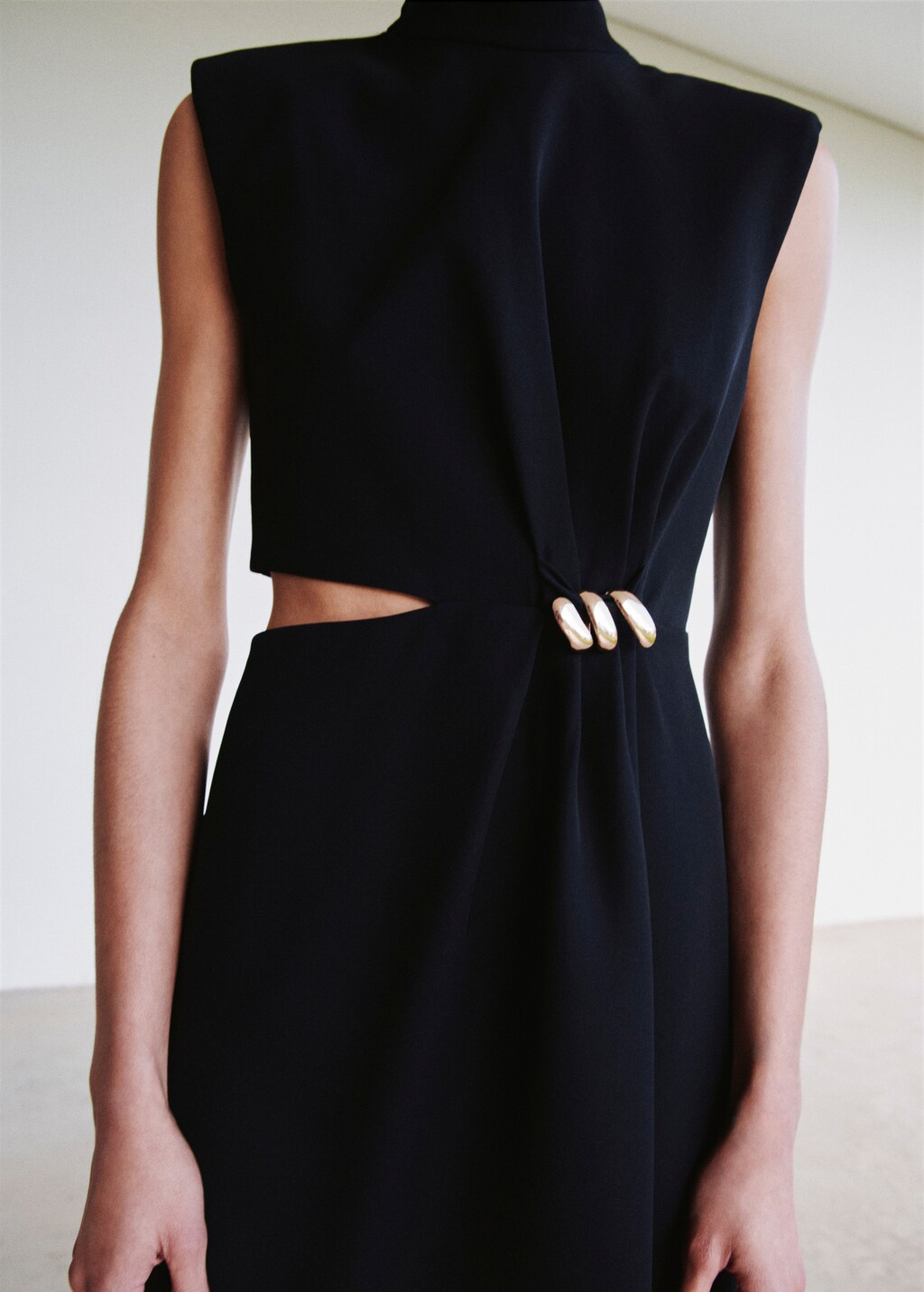 Dress with metal embellishment and cut-out