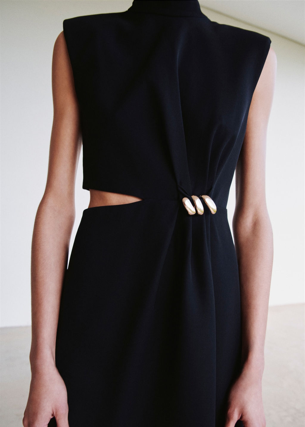 Dress with metal embellishment and cut-out