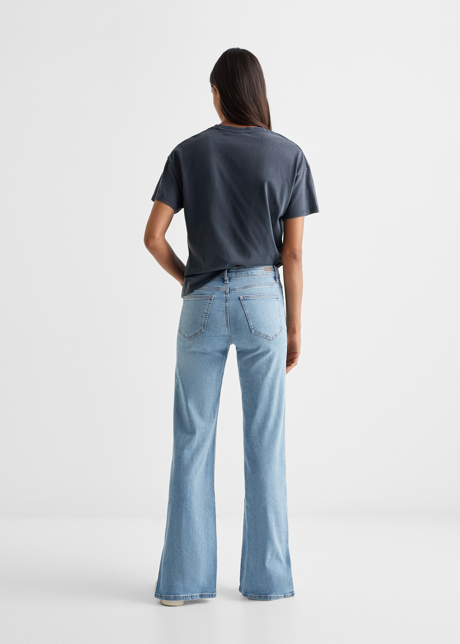 Flared jeans with opening - Reverse of the article