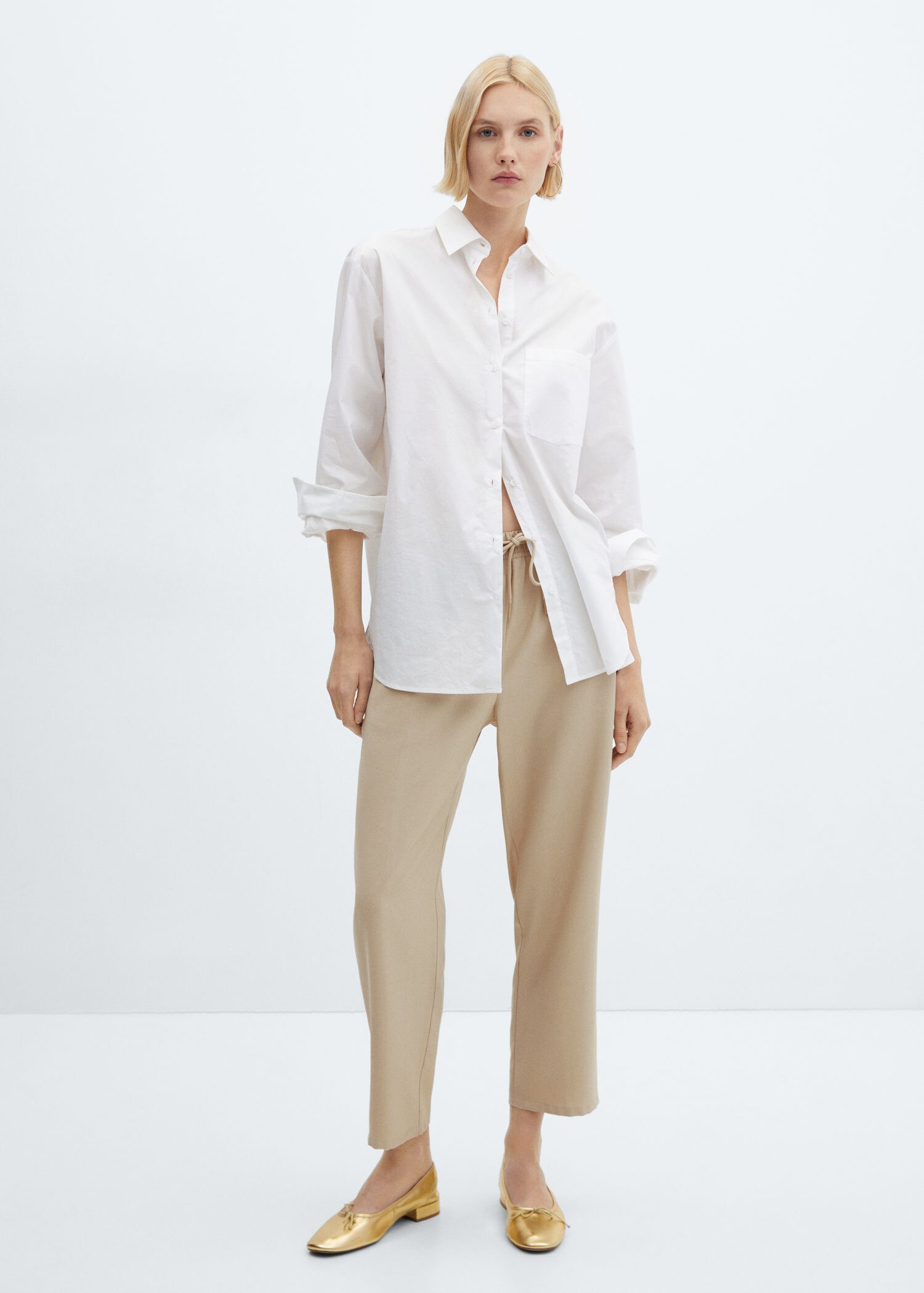 a woman in a white shirt and brown pants with a suspender Stock Photo by  Icons8