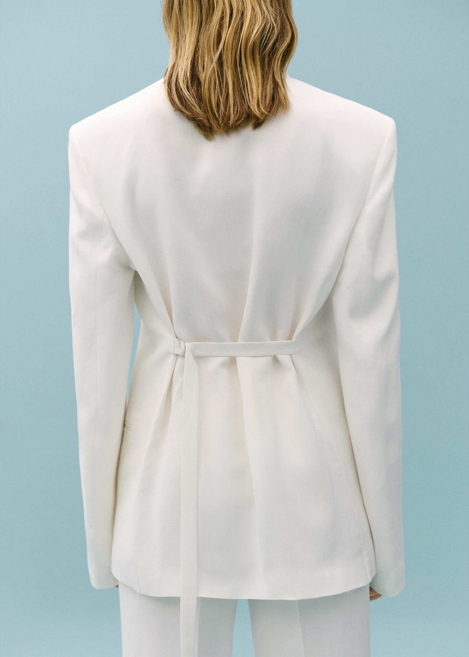 Suit jacket with adjustable back strap  - Reverse of the article