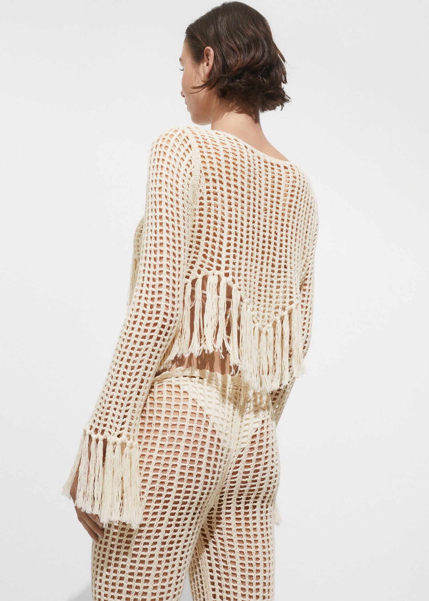 Openwork knitted sweater with fringes - Reverse of the article