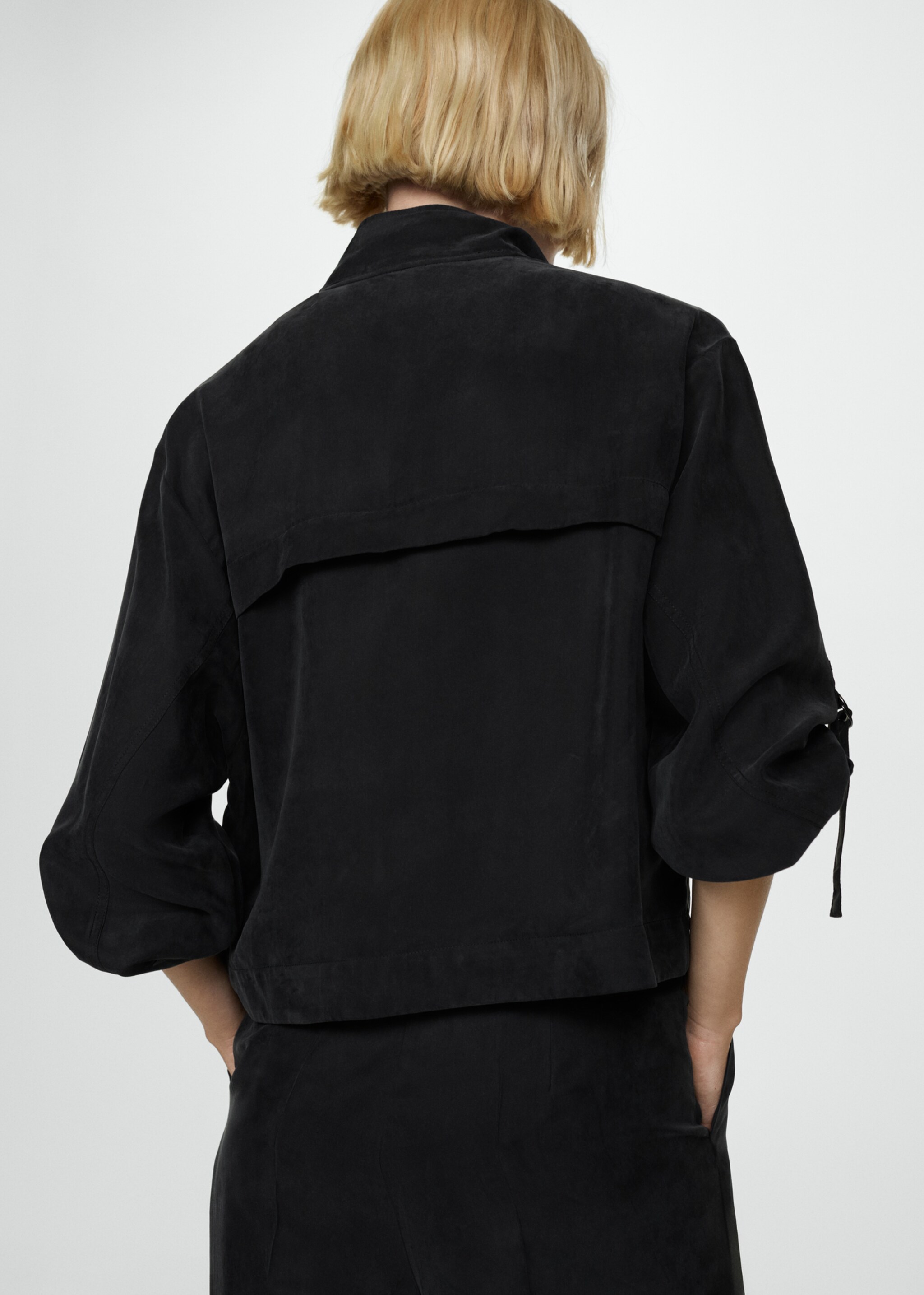 Jacket with buckle pockets - Reverse of the article