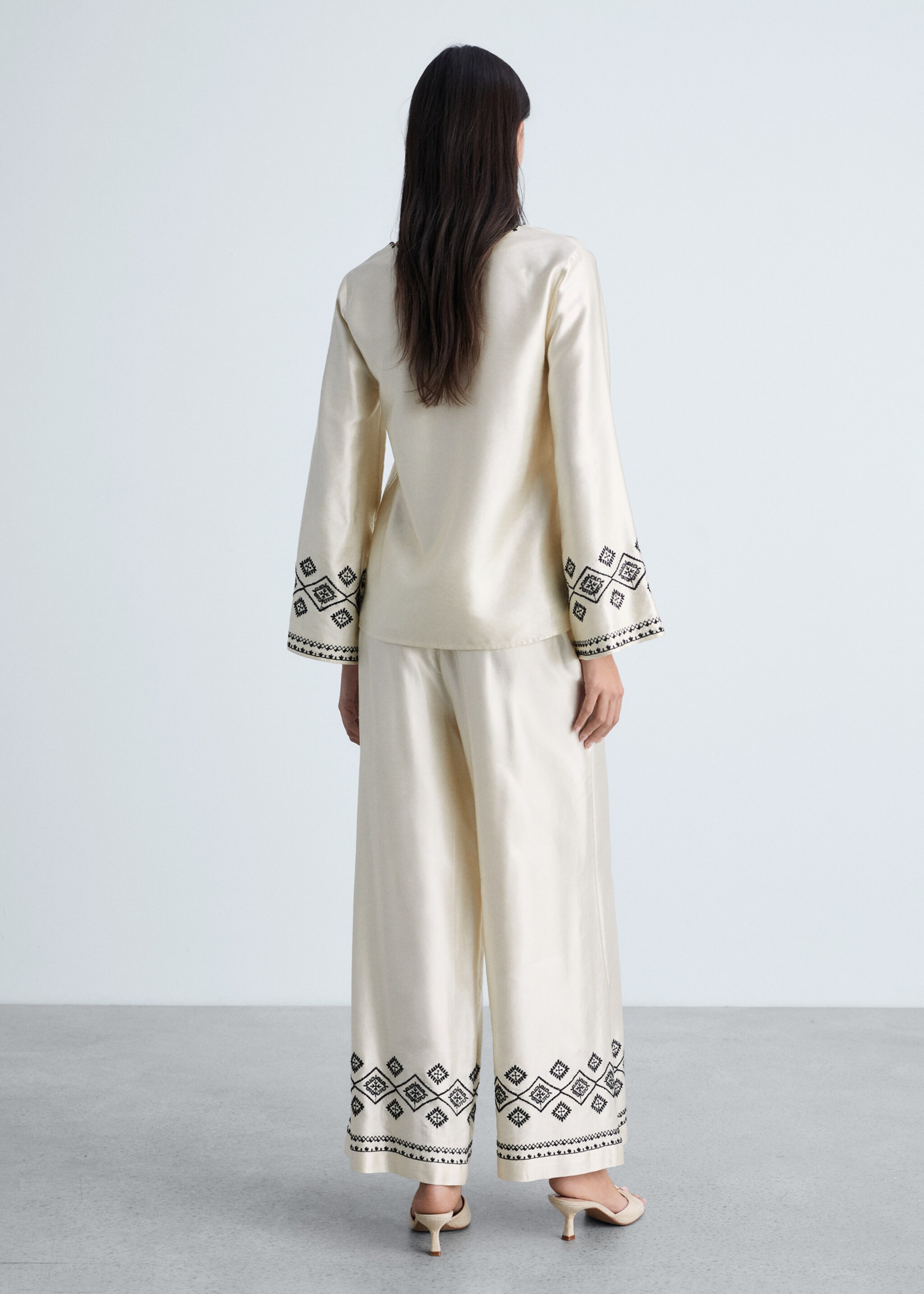 Wide-leg trousers with embroidered hem - Reverse of the article