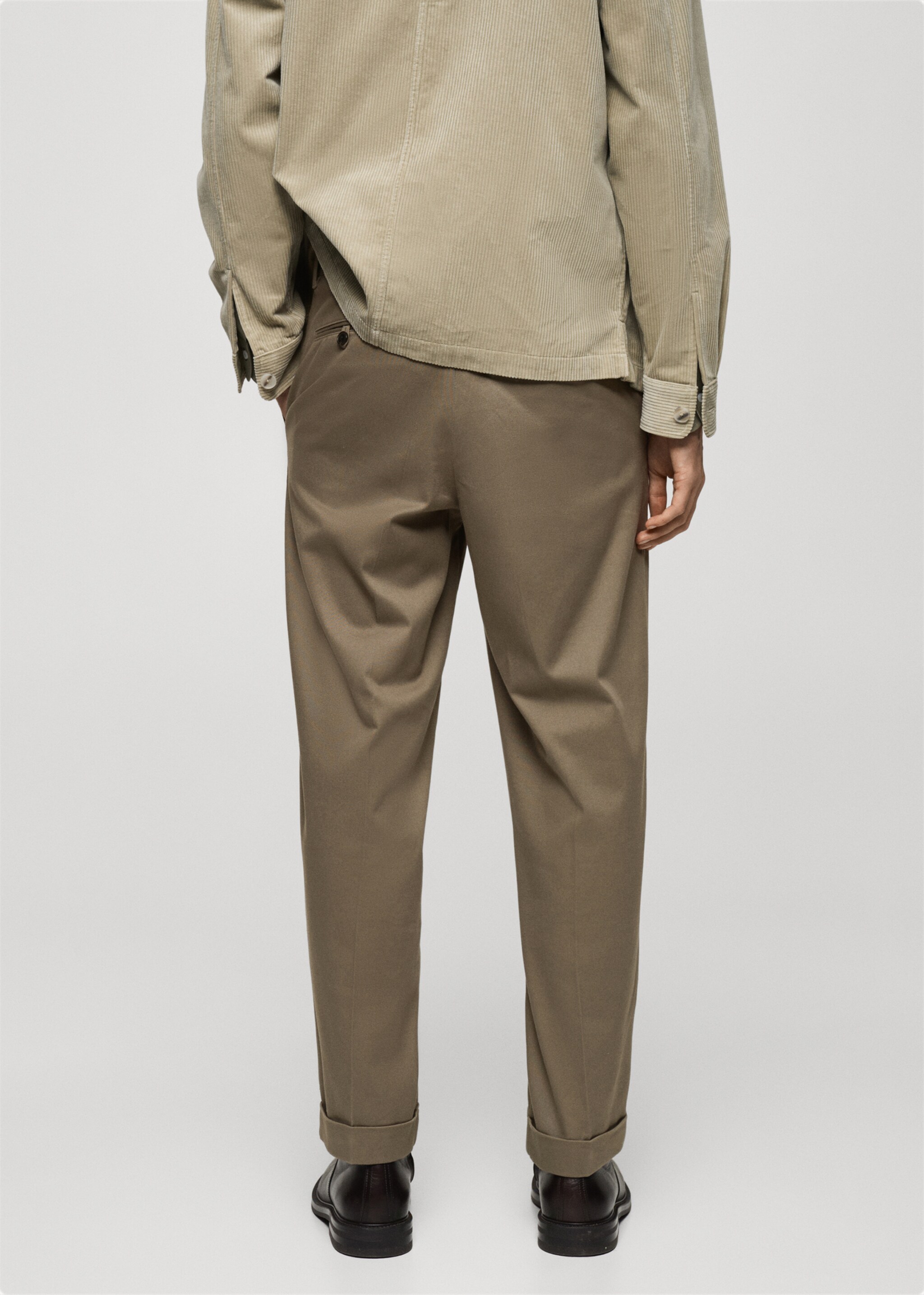 Pleated trousers under cuff - Reverse of the article