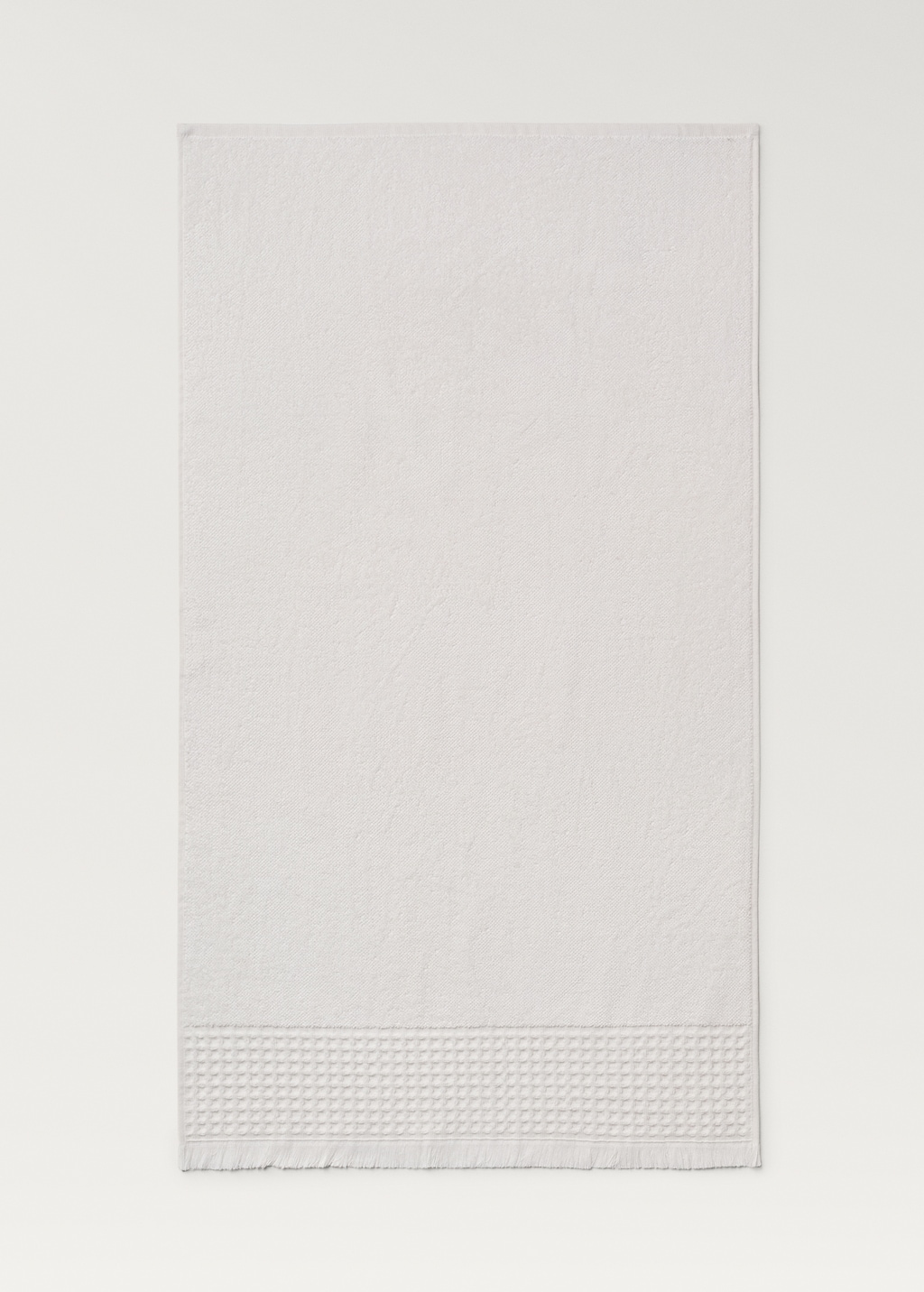 Bath towel with waffle trim and fringe