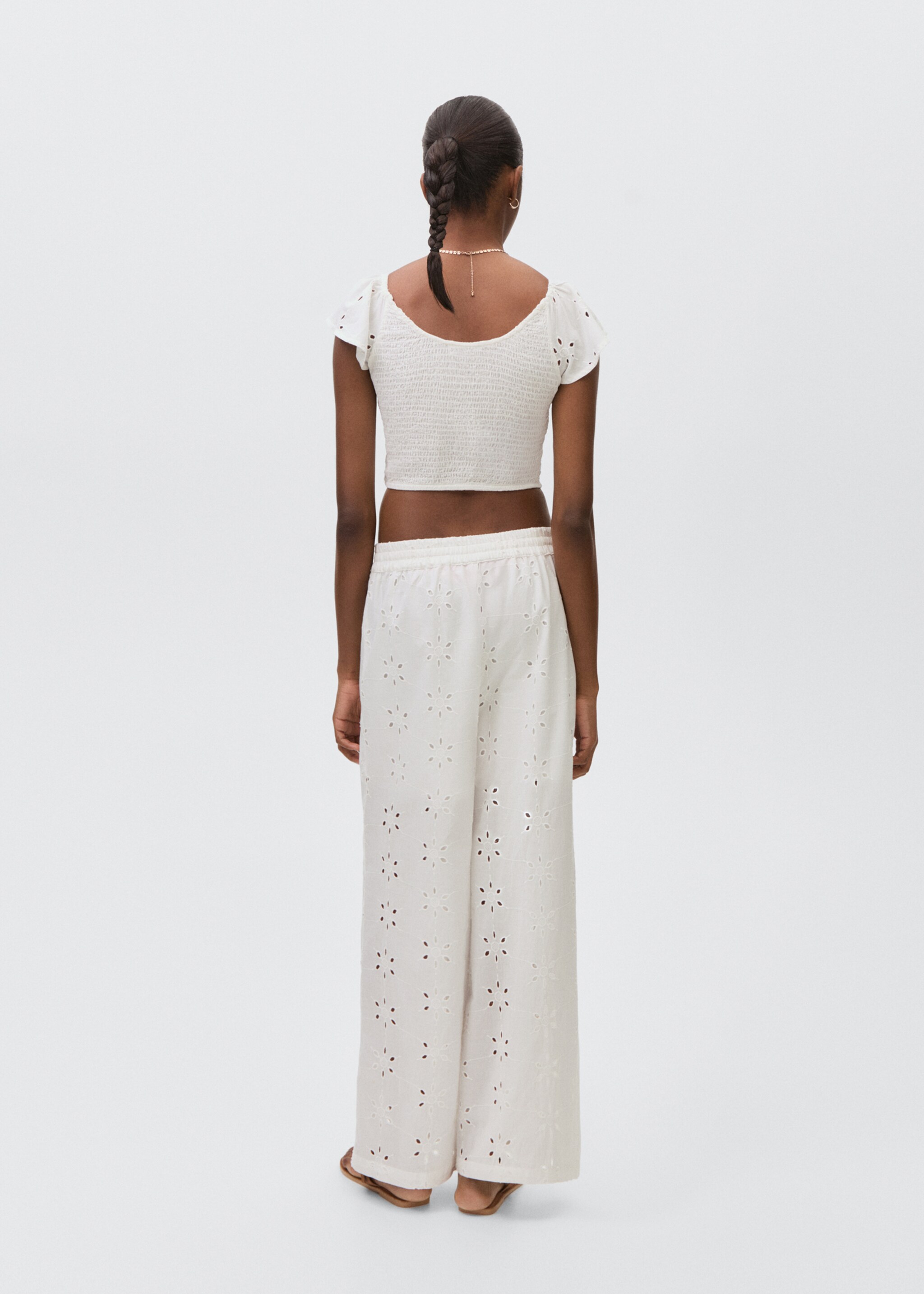Long trousers with embroidered details - Reverse of the article