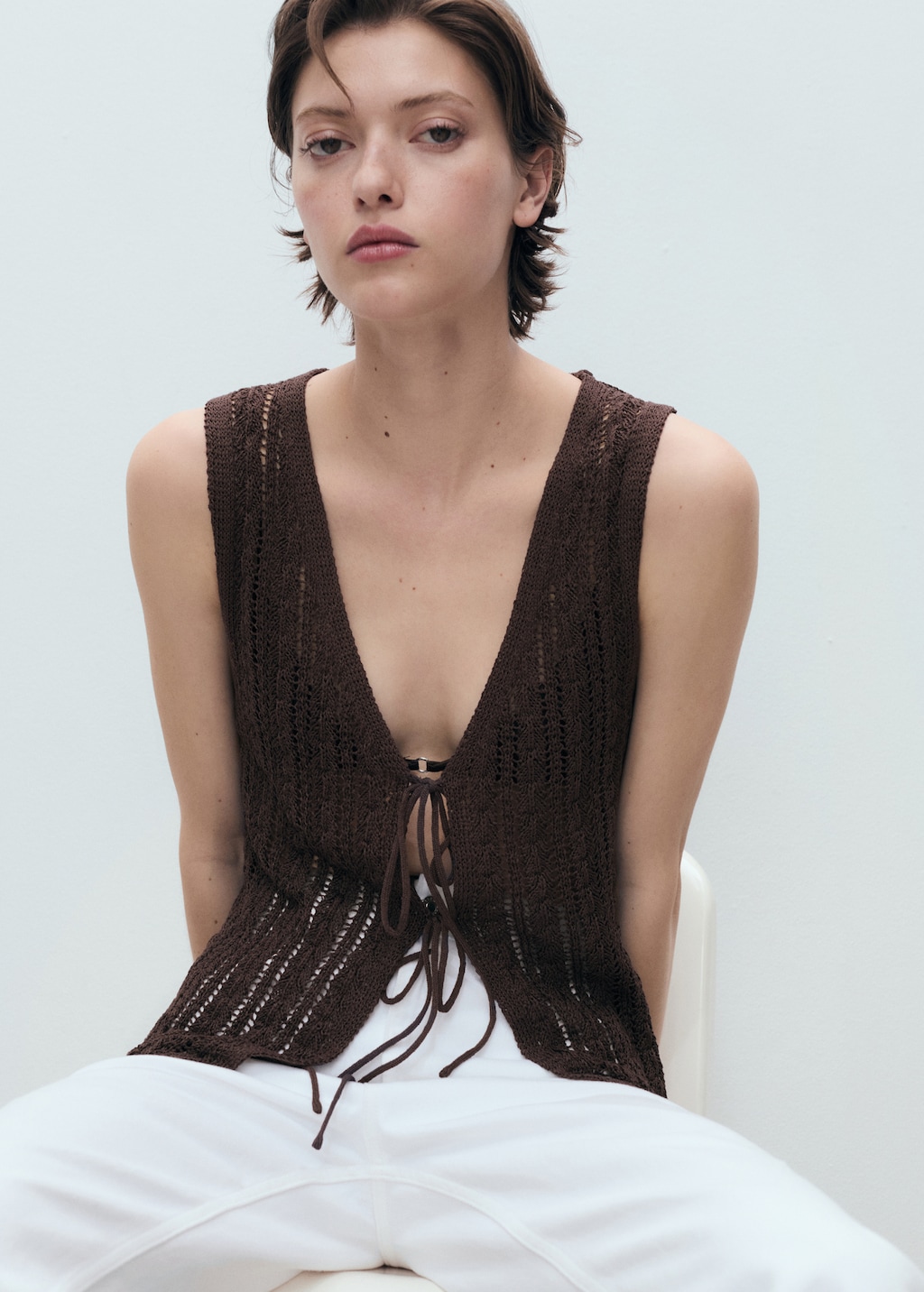 Knitted vest with bow closure