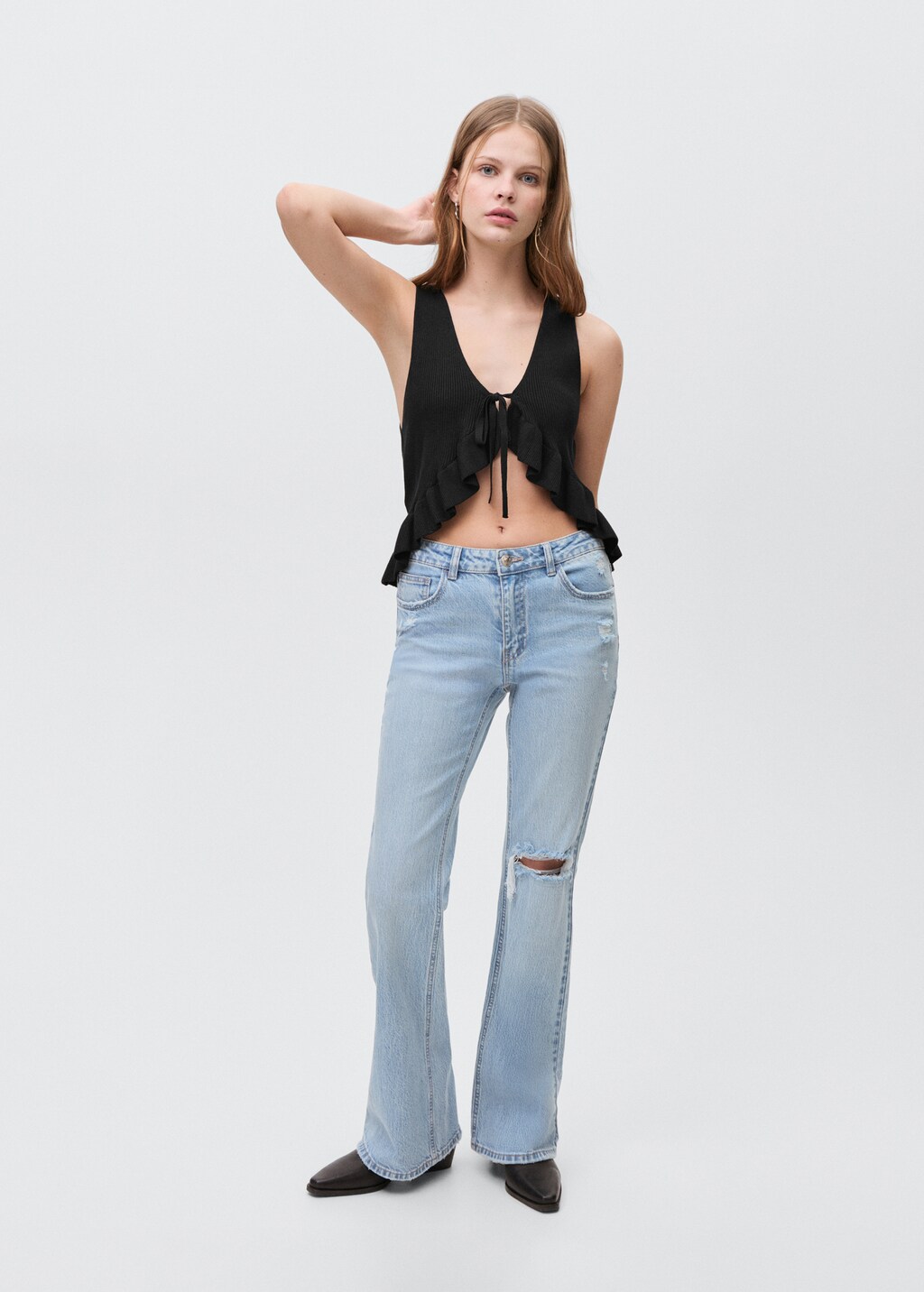 Flared jeans with decorative rips