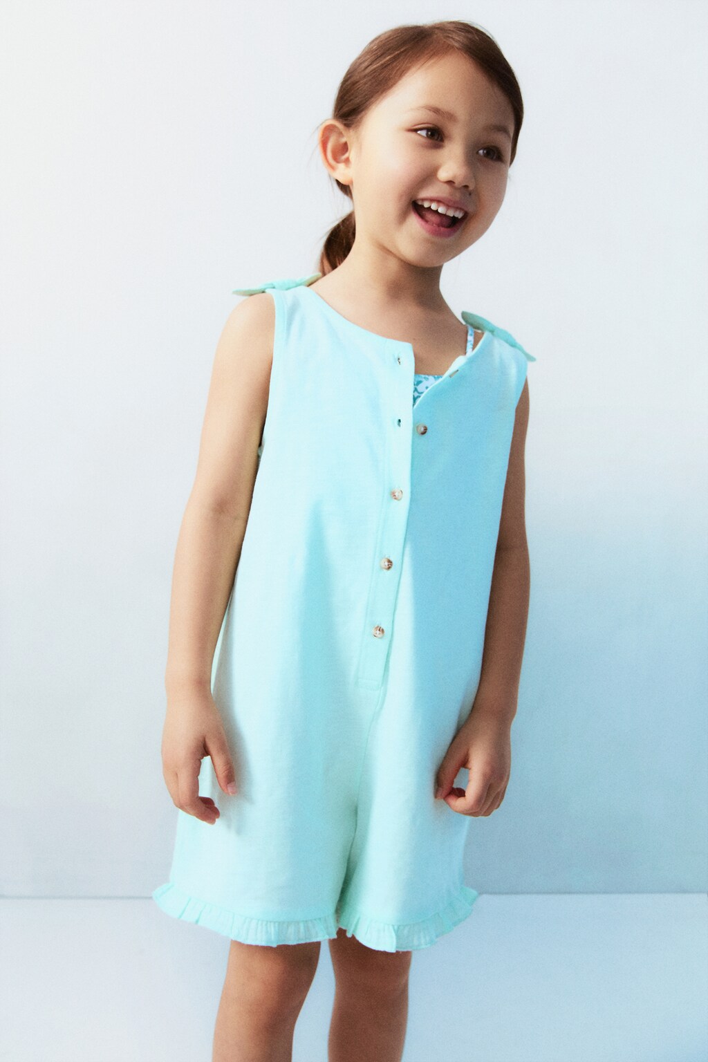 Short jumpsuit with bow detail