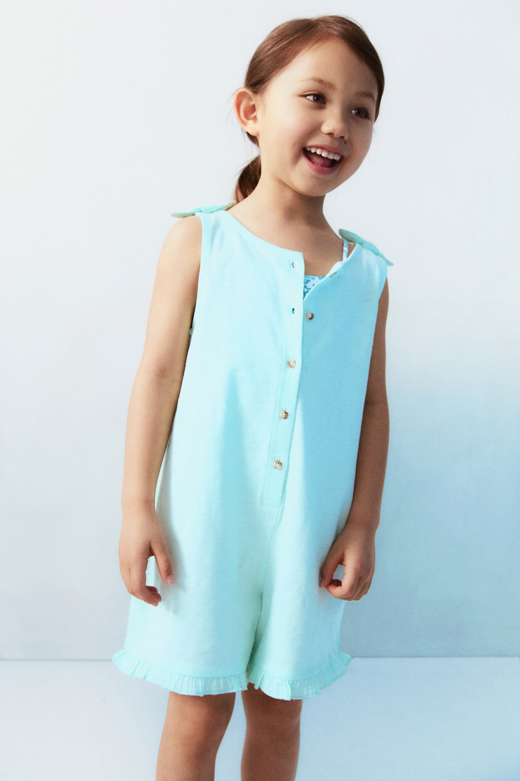 Short jumpsuit with bow detail