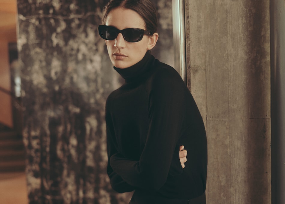 Woman wearing a minimalist style black dress