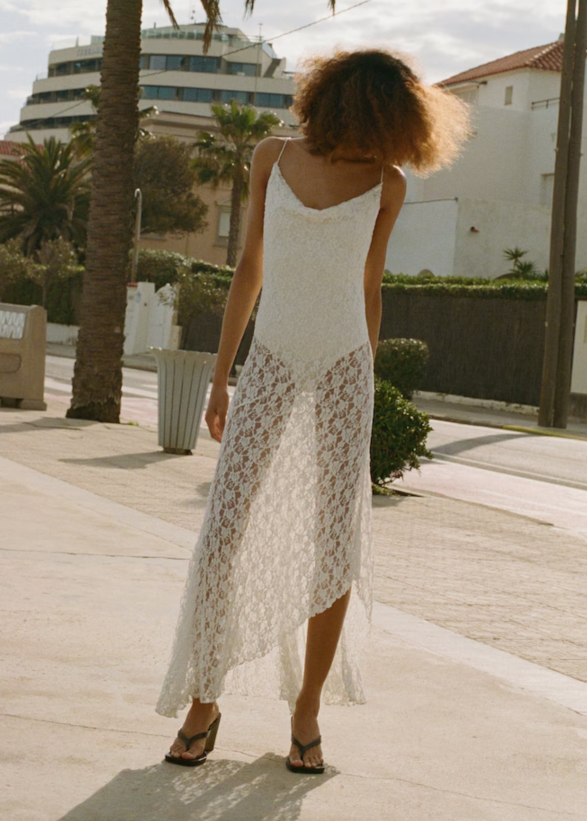 Woman wearing a festival look with a colorful skirt and a white top.