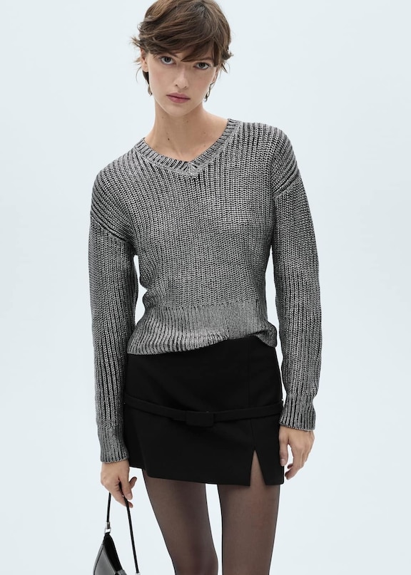 A women's outfit for Christmas 2024 with a printed sweater.