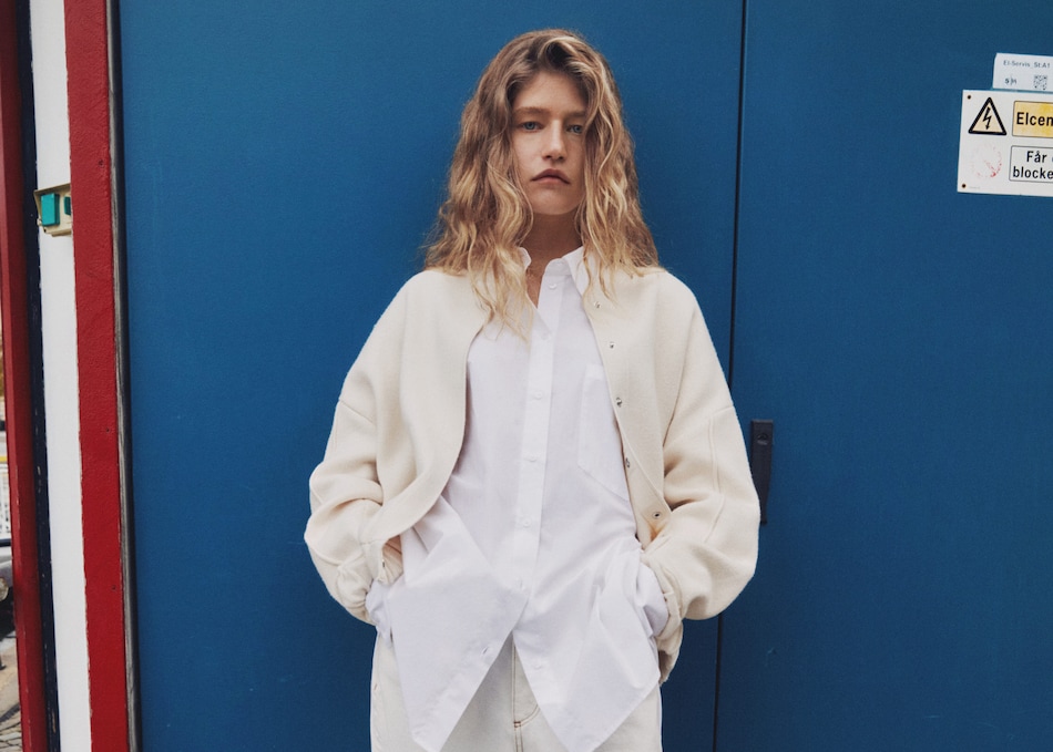 Girl wearing an oversize style look with a white shirt and jacket.
