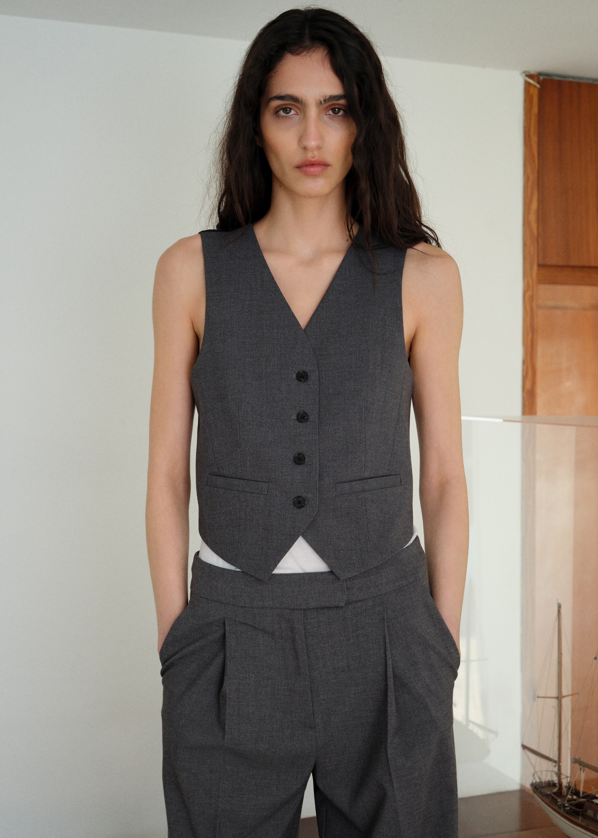 Woman wearing an outfit with a white quilted waistcoat