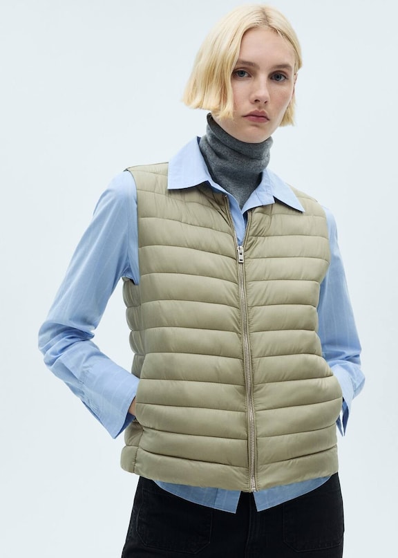 Girl wearing an outfit with a green quilted waistcoat.